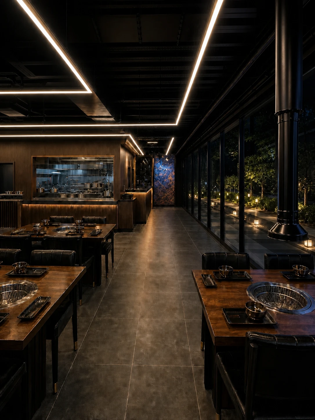 DOKEBI dining space with a transparent kitchen and nighttime exterior garden